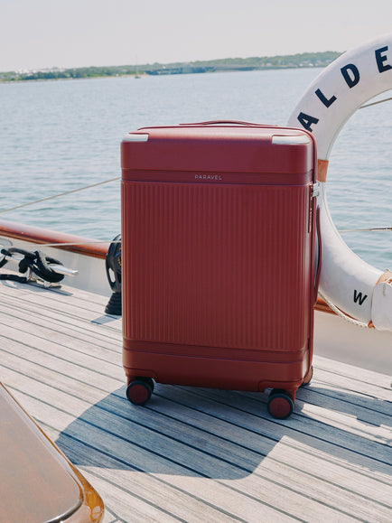 a red suitcase on a boat