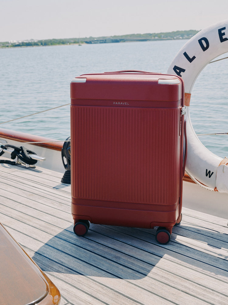 a red suitcase on a boat