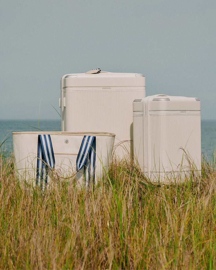 a group of luggage in a grassy area