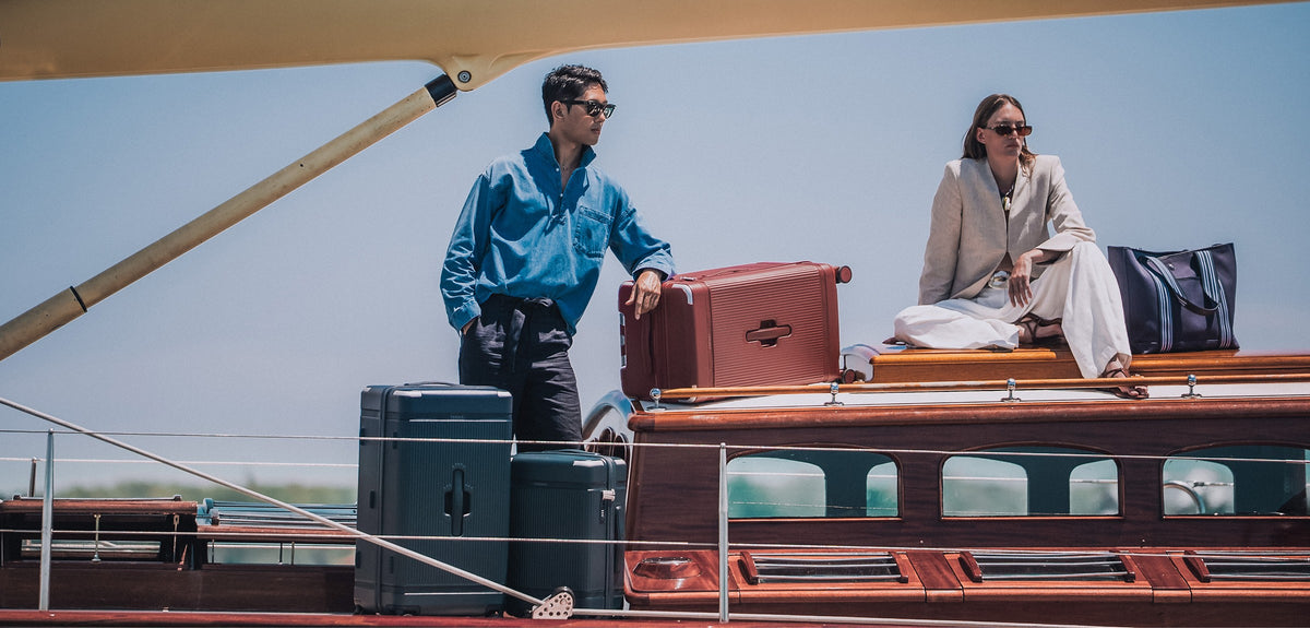 a man and woman on a boat with luggage