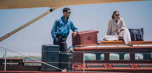 a man and woman on a boat with luggage