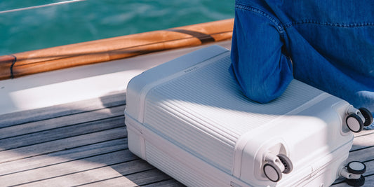 a person's feet on a white suitcase