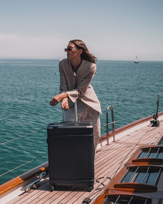 a woman with a suitcase on a boat