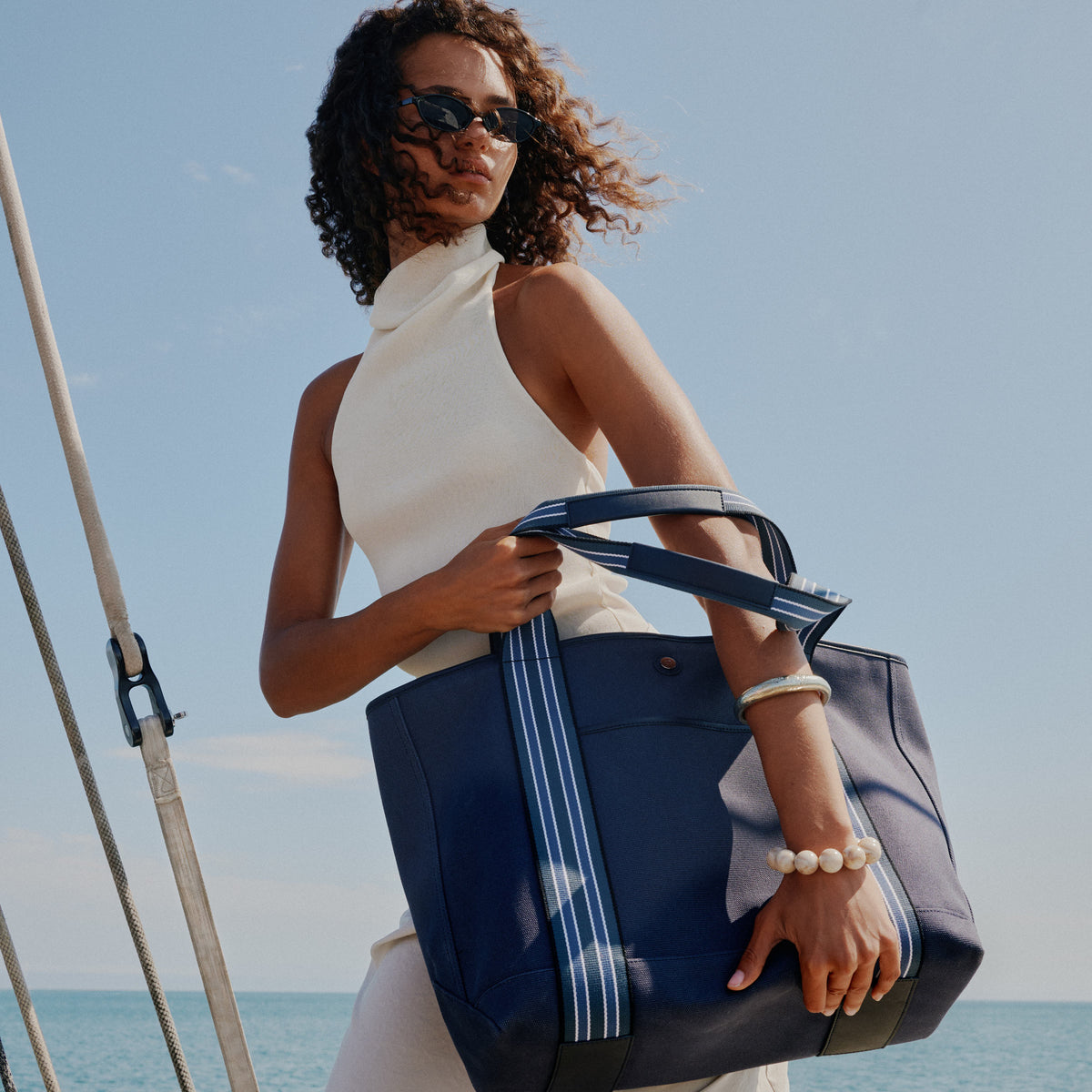a woman holding a blue bag