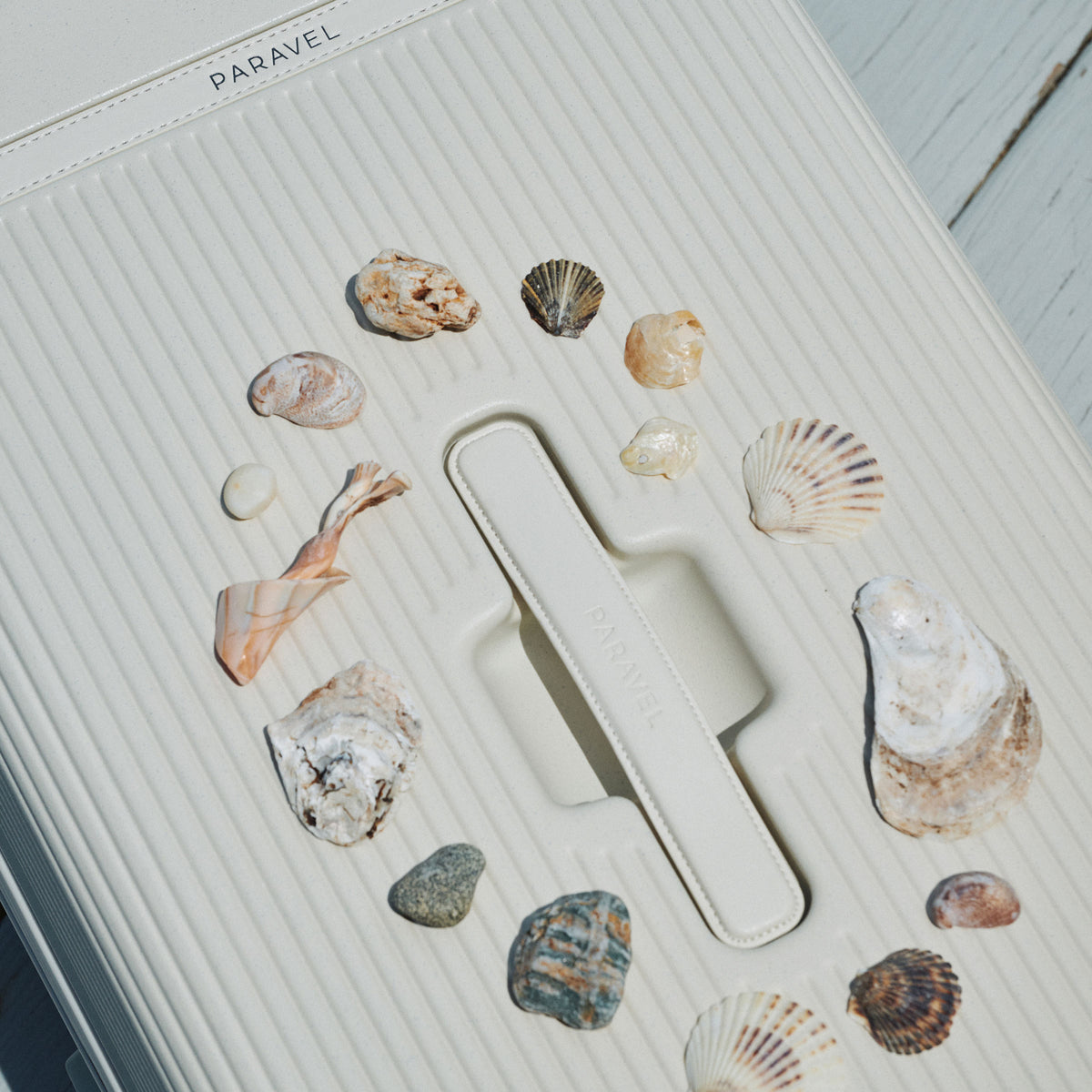 a white suitcase with shells on it