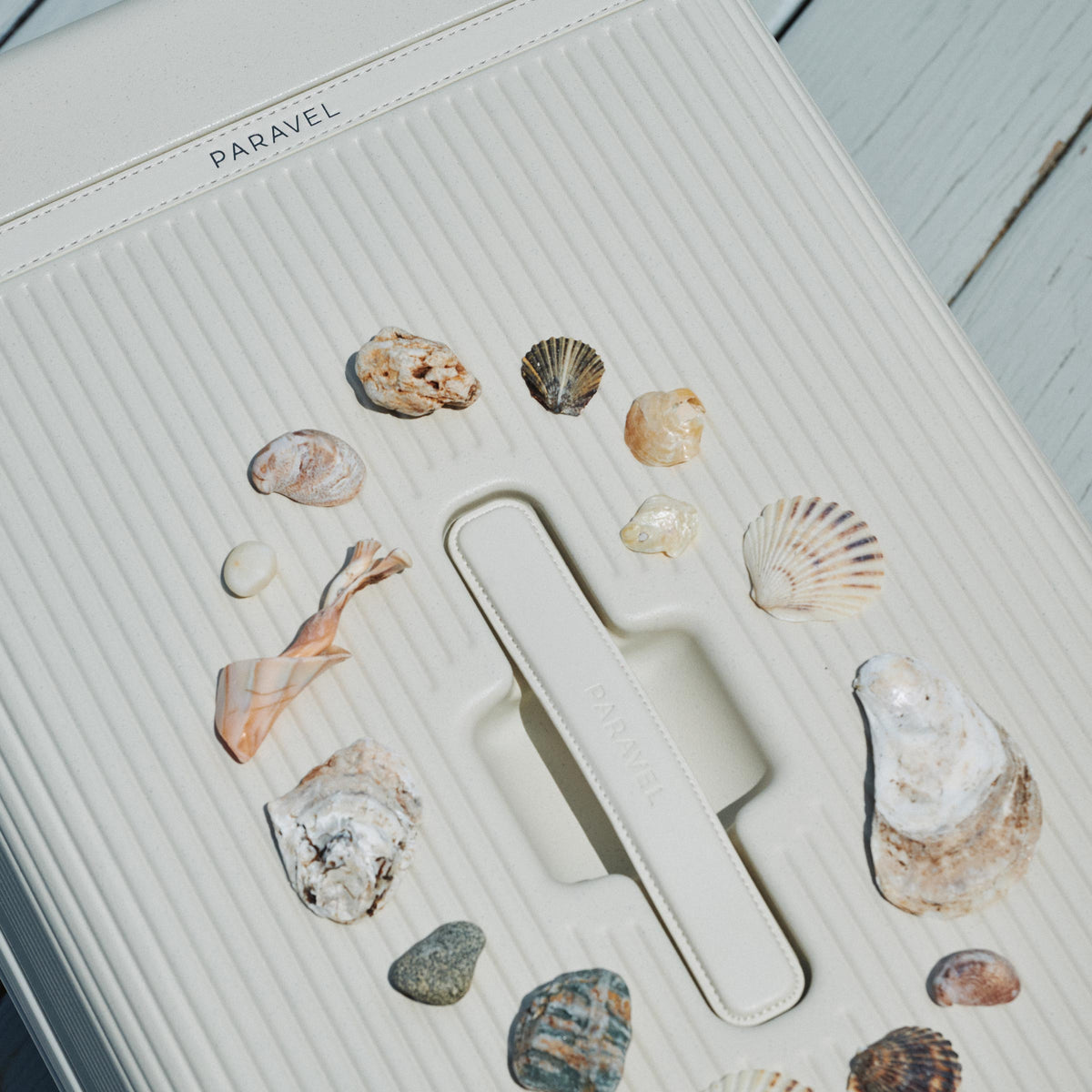 a white suitcase with shells on it