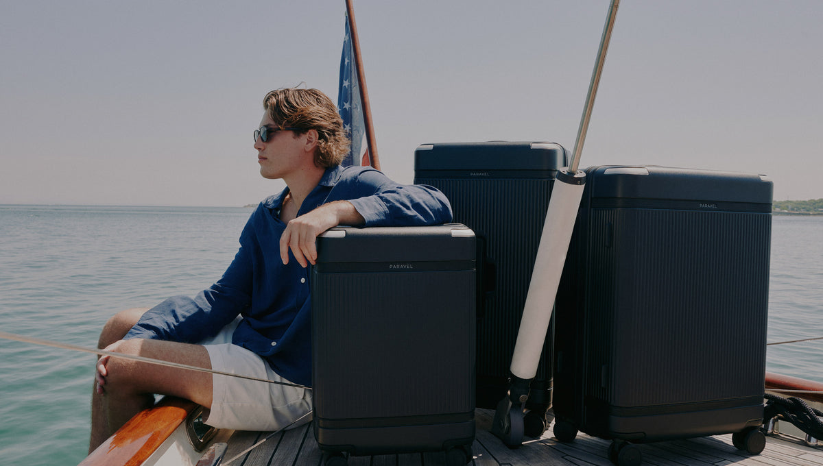 a man sitting on a boat with luggage