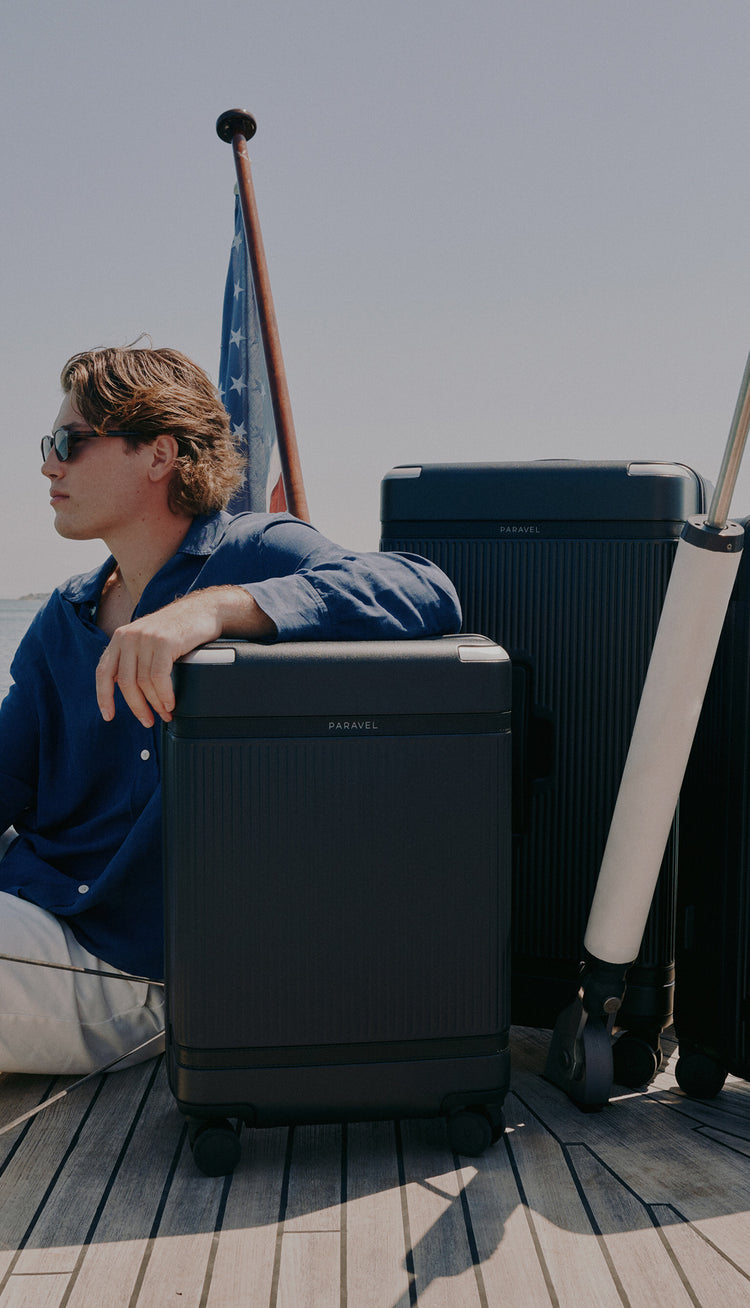a man sitting on a boat with luggage