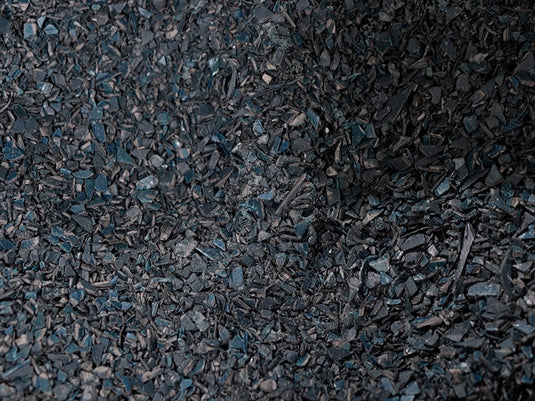 a pile of black pieces of wood