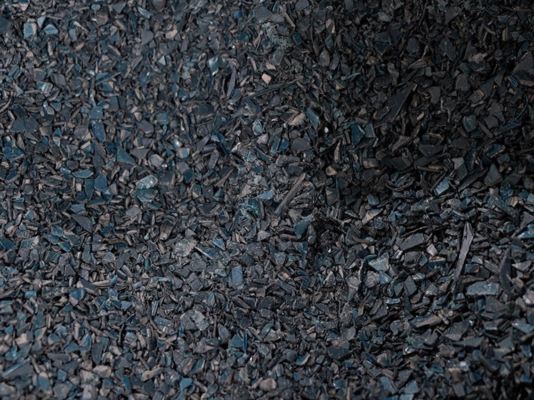 a pile of black pieces of wood