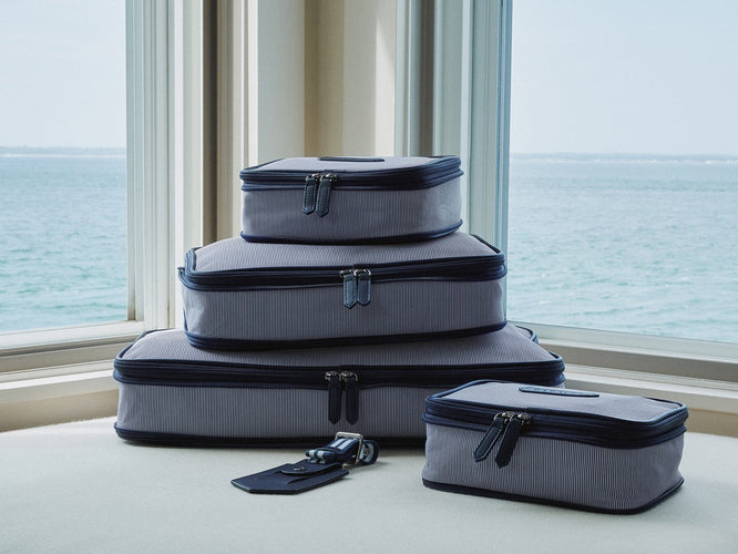a stack of luggage in front of a window