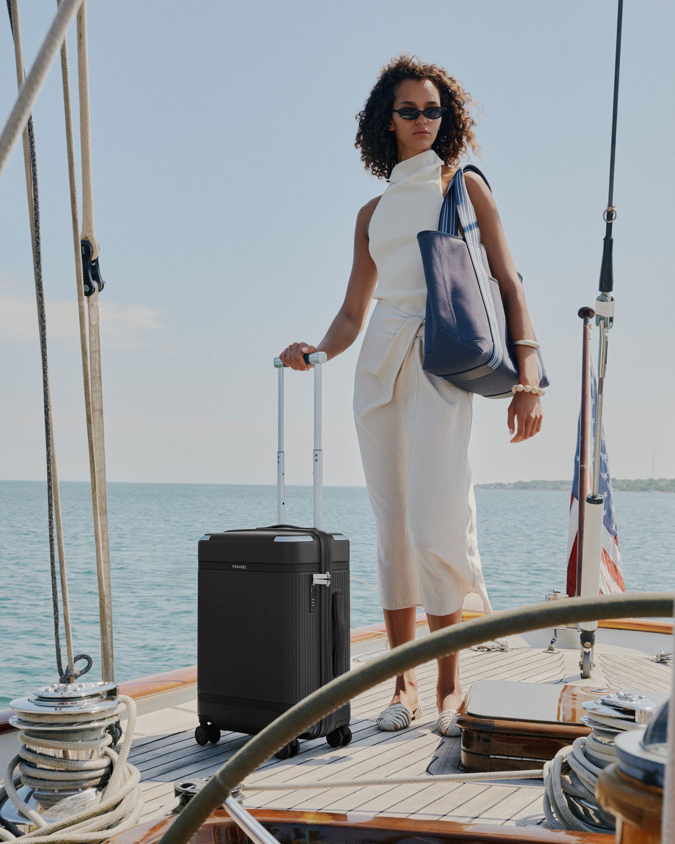 a woman standing on a boat with a suitcase