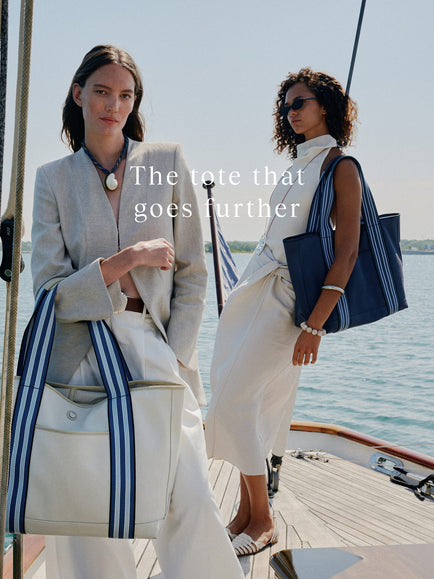 two women standing on a boat