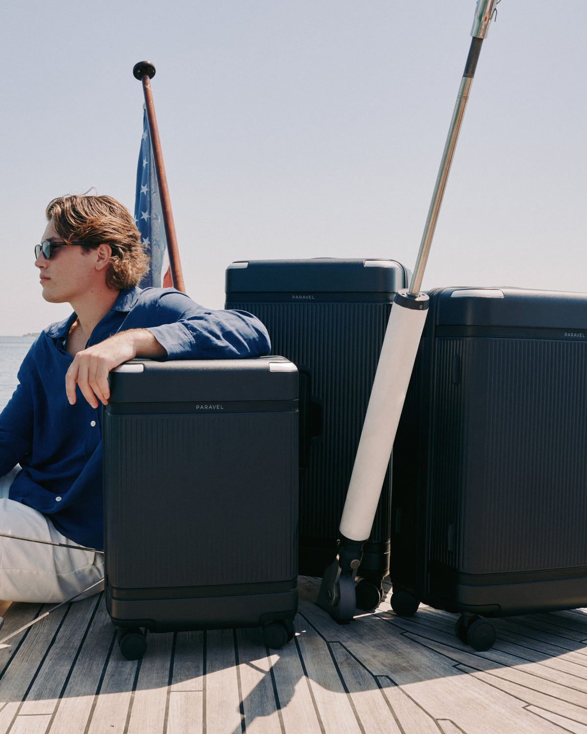 a man sitting on a boat with luggage